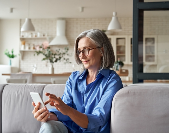 Lady Using Cell Phone On Couch
