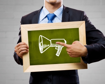 man pointing to mega phone