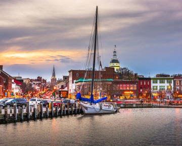 Annapolis by the water with a boat and buildings in background