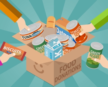 people filling box with food drive items