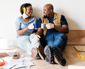 couple sitting on floor and drinking coffee