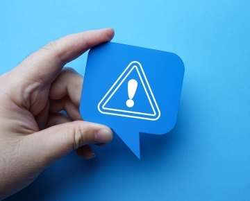 Hand holding an icon triangle