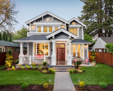 gray home with brown door and wood fence