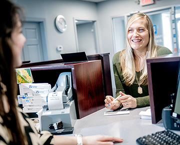 Customer Smiling and Talking to Teller